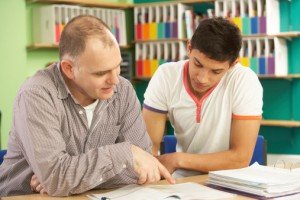 How to Get Top Marks With Your Start-Up Tutoring Business - image - male tutor teaching male student