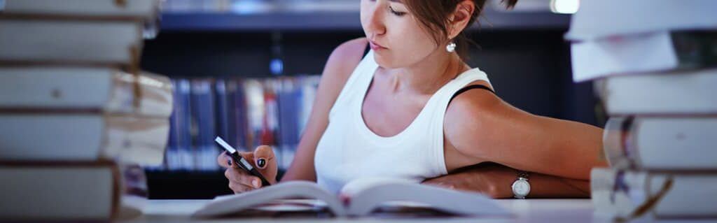 5 Great Reasons To Start A Business At University - image - woman studying in library