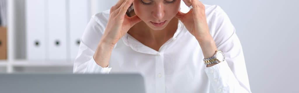 Common Misconceptions when Setting up a Business - image - woman holding head in hands