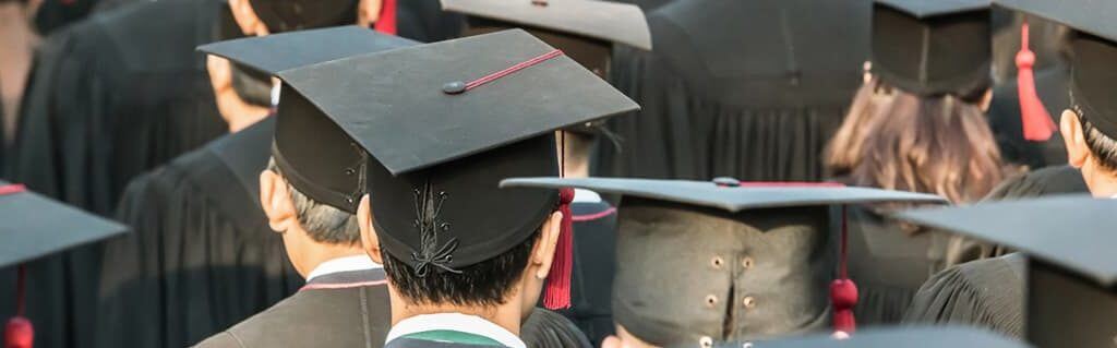 How University Can Open Your Mind to Enterprise - image - backs of university students heads wearing graduation caps