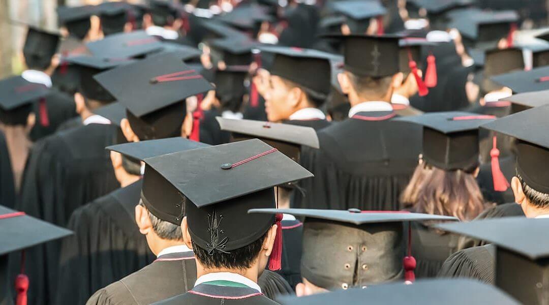 Group of students on graduation day looking toward entrepreneurship