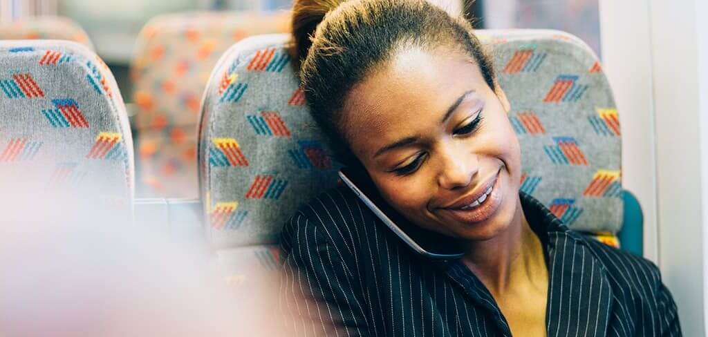 Female business owner using a mobile device on a train